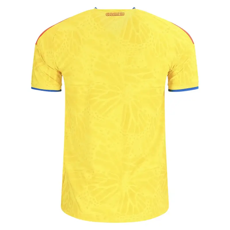 Back of yellow Colombia soccer jersey with butterfly pattern.