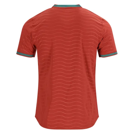 Back view of a red soccer jersey with teal trim.